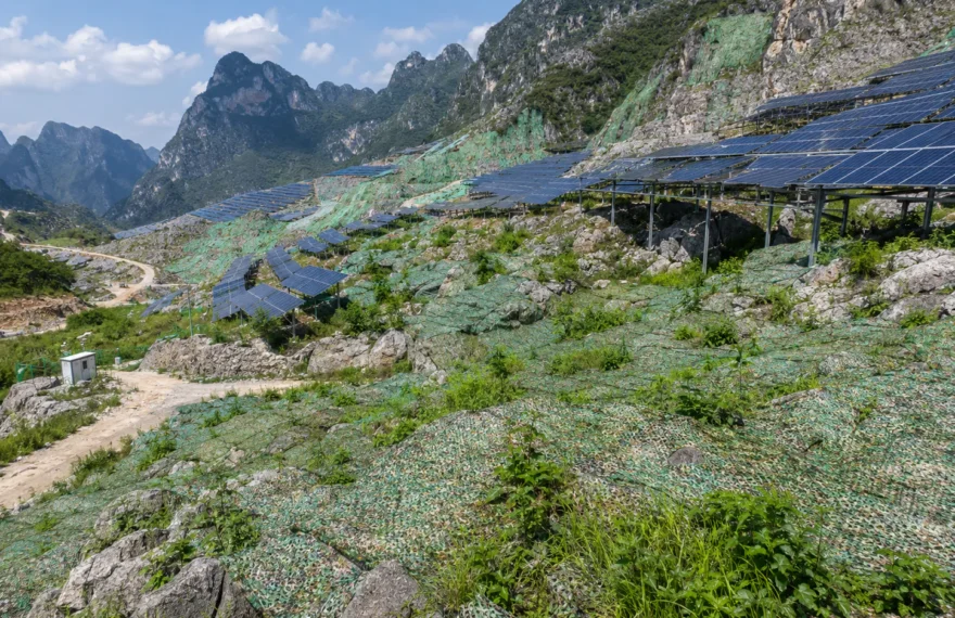 Agrivoltaic desertification control site with ecological camouflage netting on rocky slopes