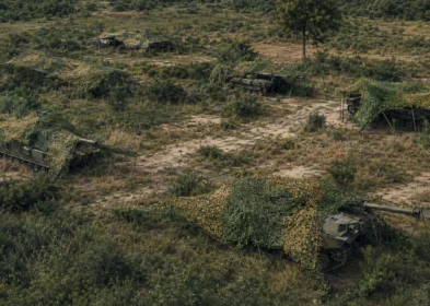 Armored unit concealment demonstration using terrain-matched camouflage netting