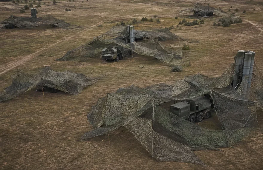 Field archaeological dig site covered by protective camouflage netting