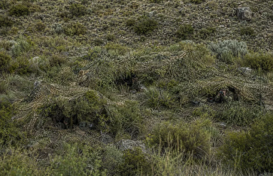 Infantry observation position concealed with lightweight camouflage netting