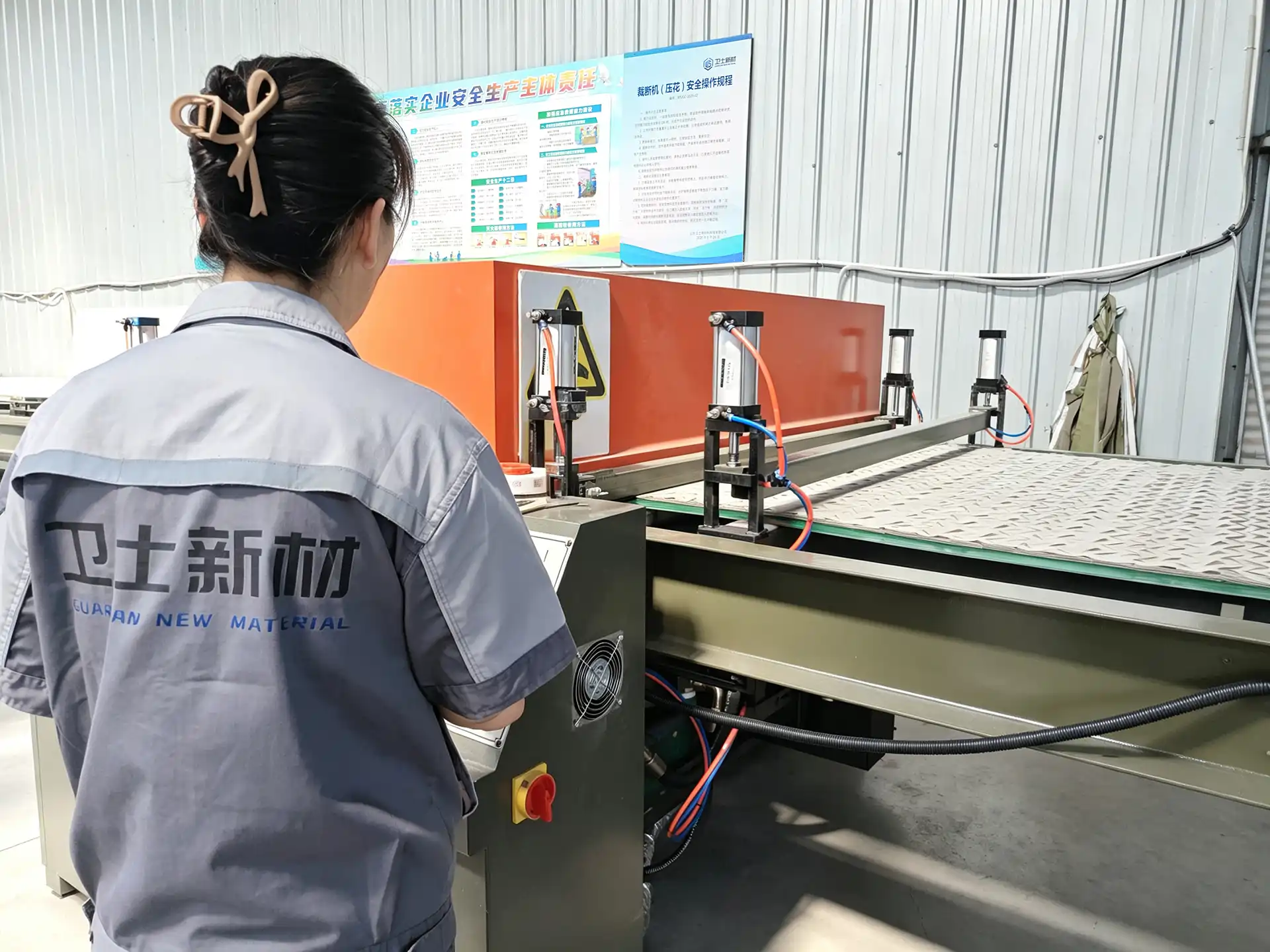 Operator monitoring automated camouflage fabric cutting equipment