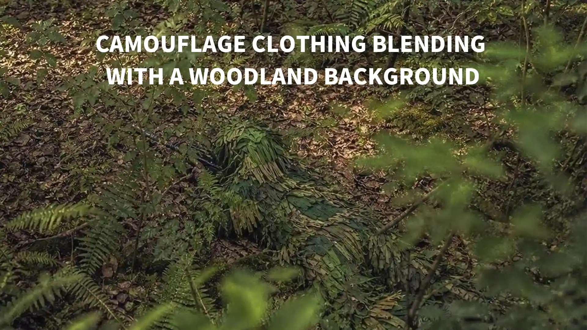 Person wearing woodland camouflage clothing among trees, leaves, and natural shadows