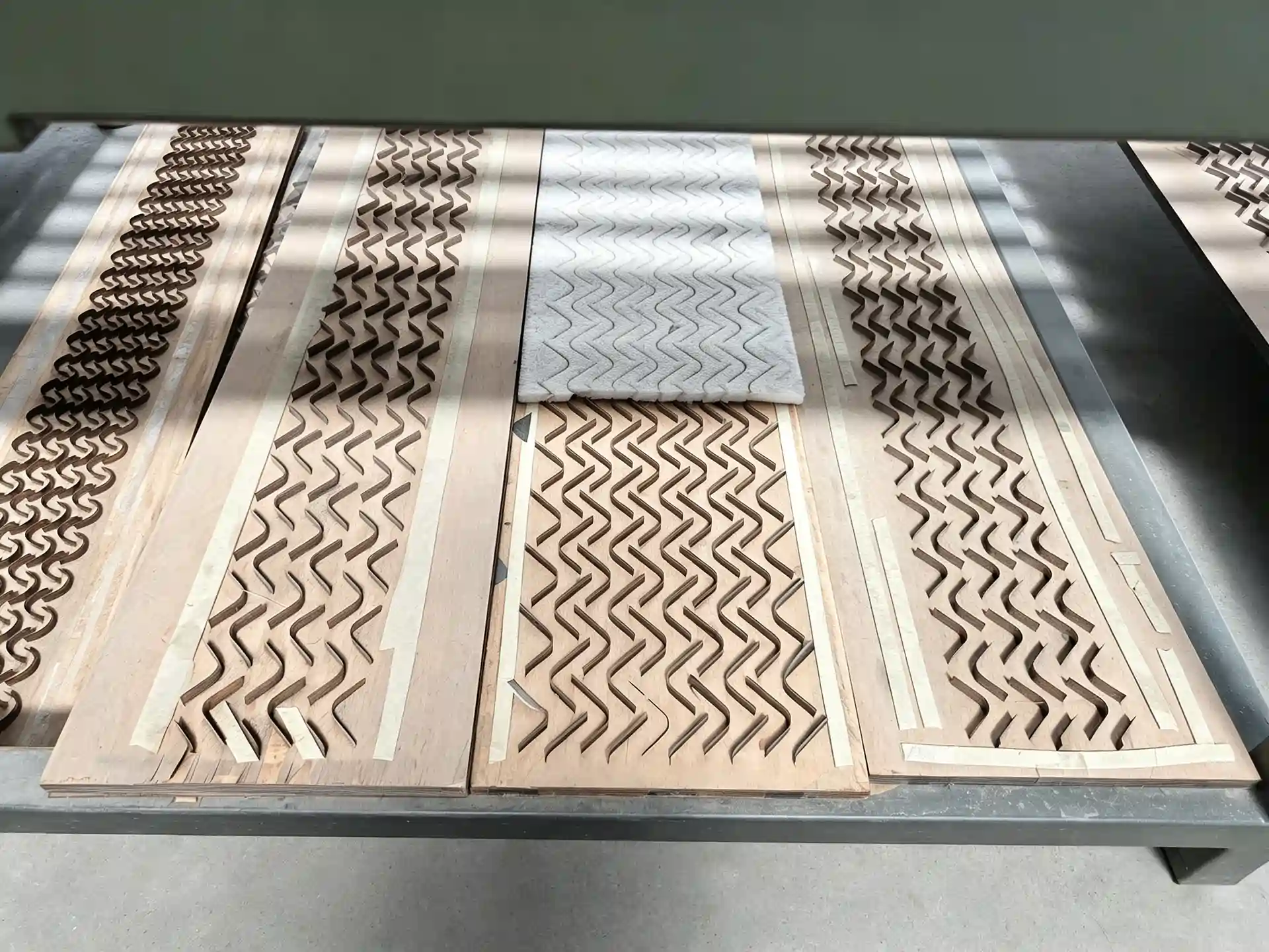Cut camouflage decorative components arranged on a production table