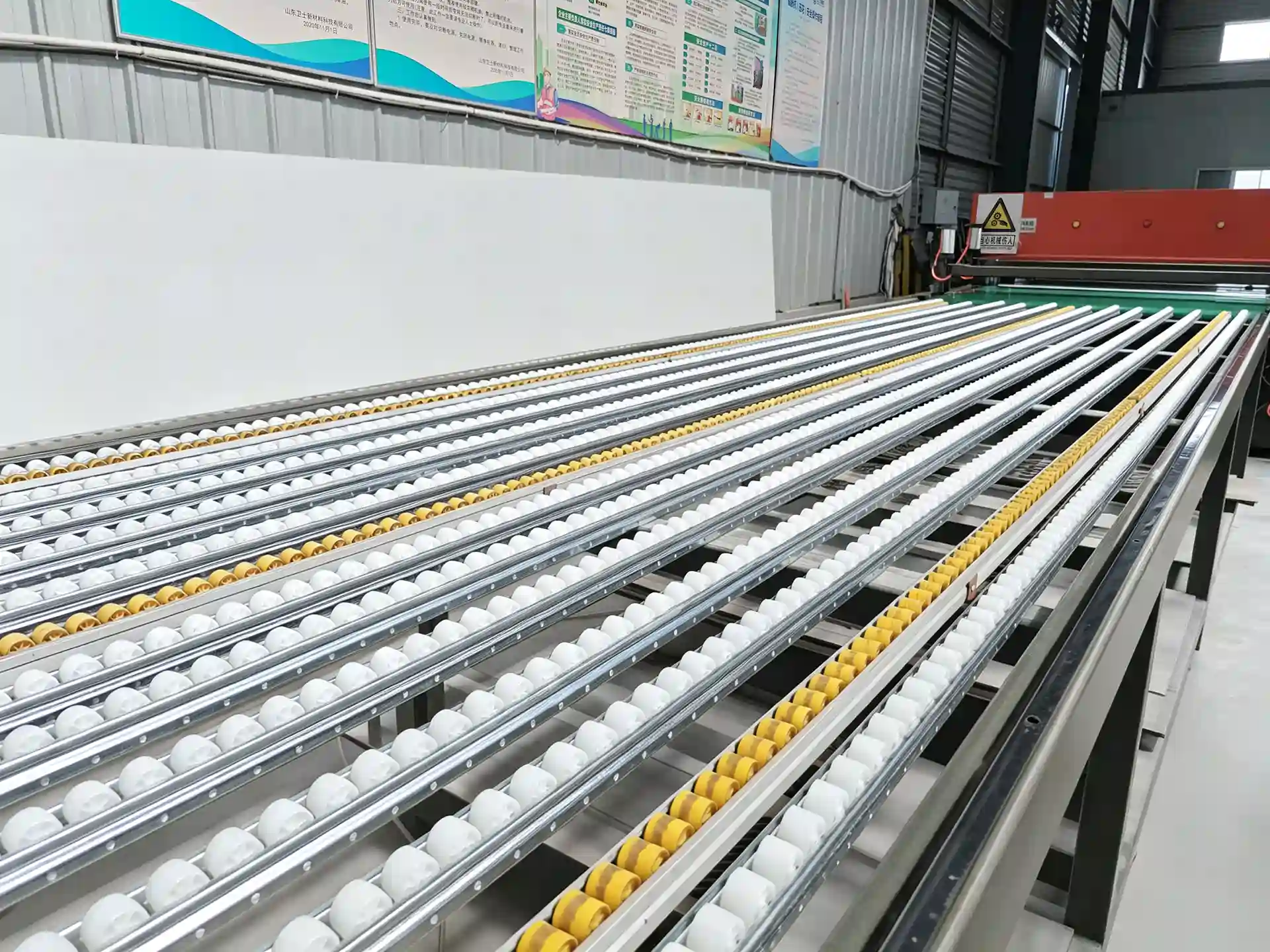 Roller conveyor section of a camouflage material production line
