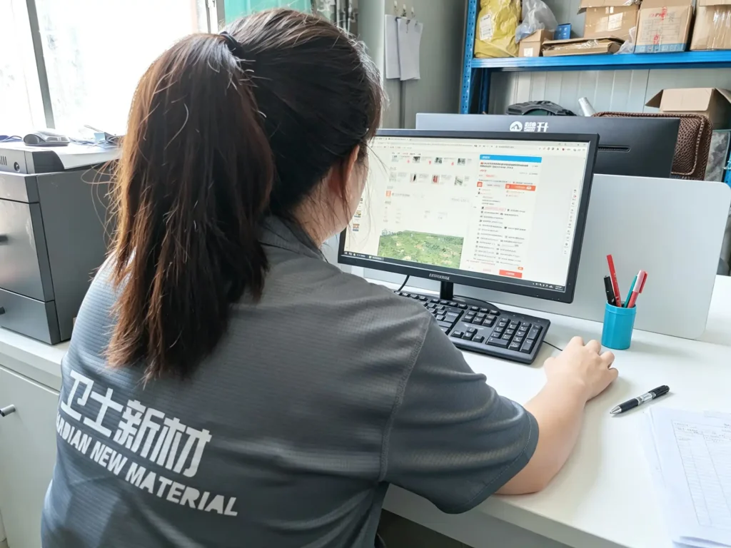 Shijie technician preparing camouflage production files at a computer workstation