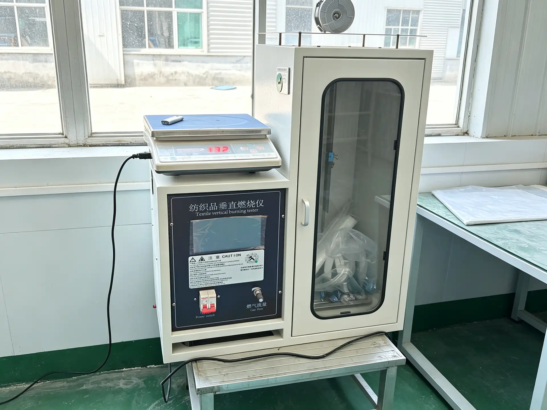 Vertical flammability tester used for camouflage textile testing