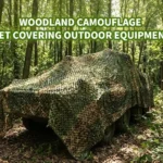 Woodland camouflage net draped over outdoor equipment to break up its visible outline